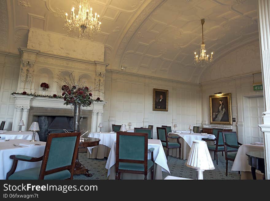 A luxury old dinning room in a lovely hotel, with an open fire place and chandeliers. A luxury old dinning room in a lovely hotel, with an open fire place and chandeliers.