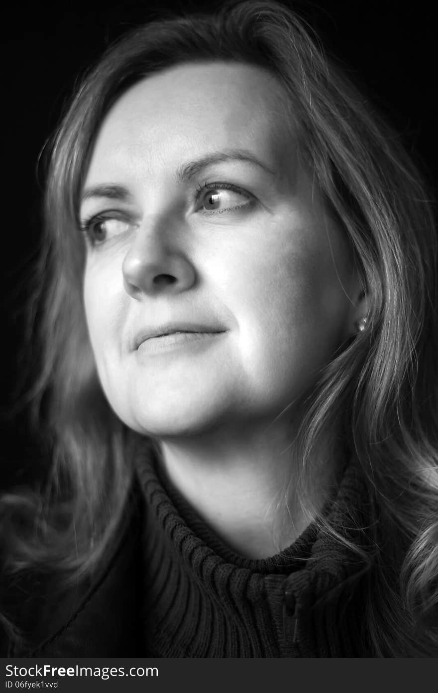 Portrait of a blonde woman on a black background. Portrait of a blonde woman on a black background.