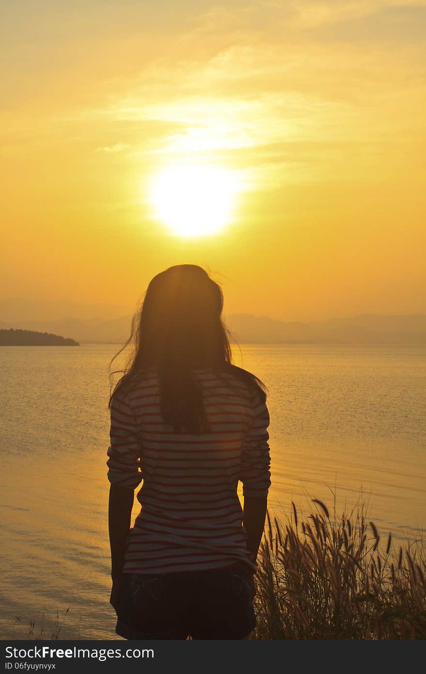 Young girl and sunset scene