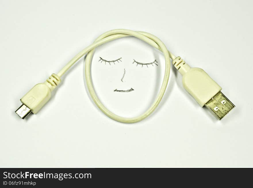 Smile and USB cable on a white background. Smile and USB cable on a white background