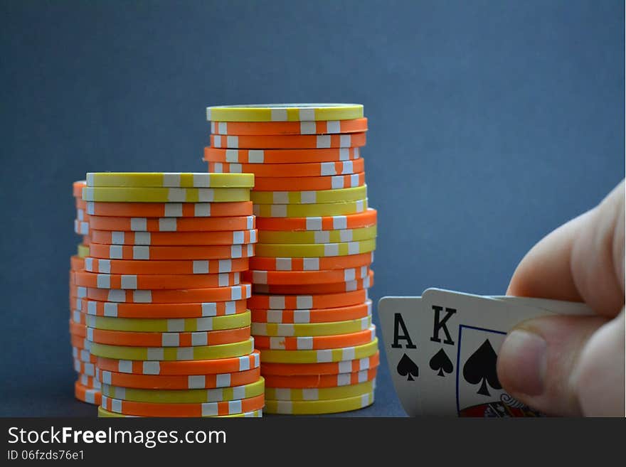 Playing cards held by hand with chips. Playing cards held by hand with chips