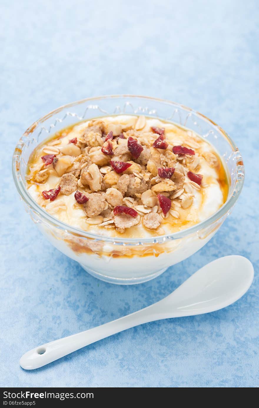 Homemade natural yogurt with maple syrup, granola