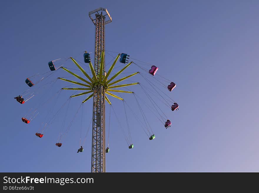 Tall funfair ride with sky background