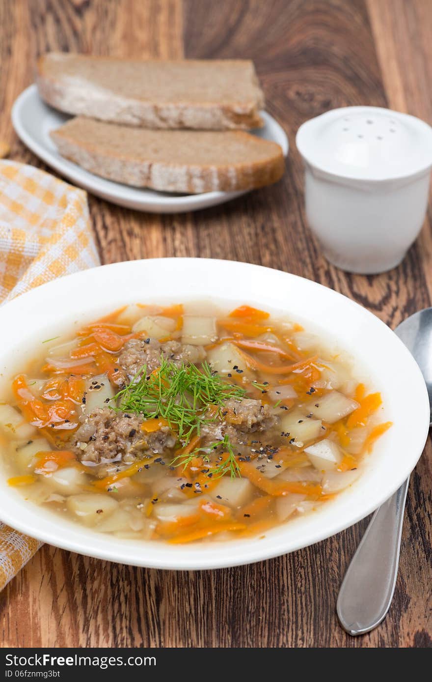 Vegetable soup with meatballs, vertical, close-up