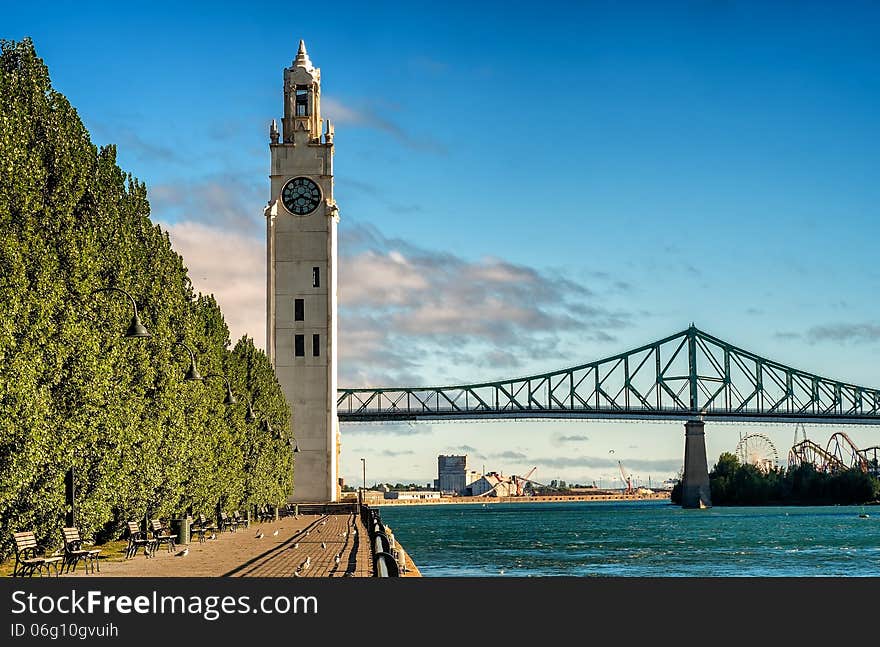 The clock tower located in the heart of Old Montreal beside the St-Lawrence river with Jacques Cartier bridge and a entertainment pack