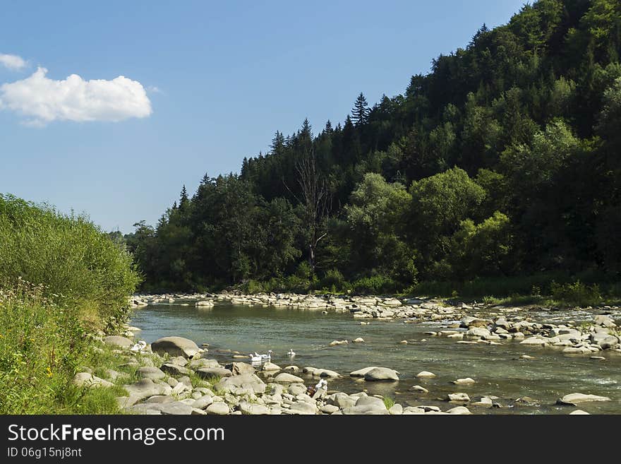 Flowing river at the base of the mountains