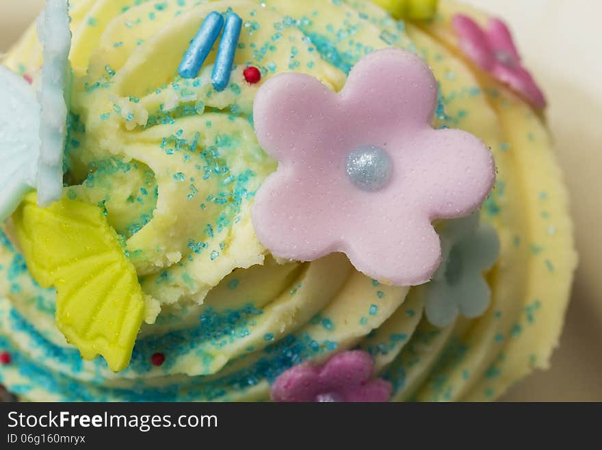 Delicious muffin with cream and sugar flowers. Delicious muffin with cream and sugar flowers