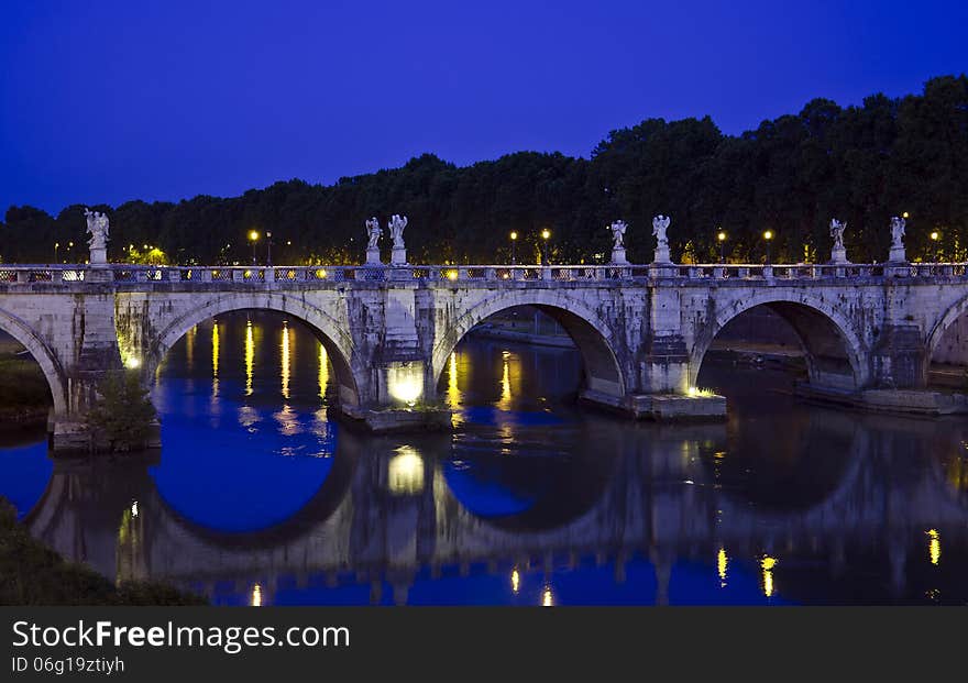 Night view of Sant Angelo Bridge, in Rome, Italy. The bridge was completed in 134 AD by Roman Emperor Hadrian. Night view of Sant Angelo Bridge, in Rome, Italy. The bridge was completed in 134 AD by Roman Emperor Hadrian.