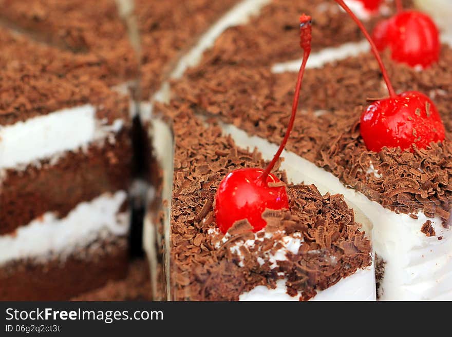 Cake with chocolate and cherry on top