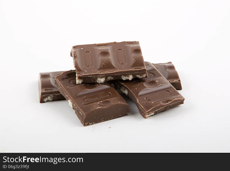 Milk chocolate with cookies on a white background.