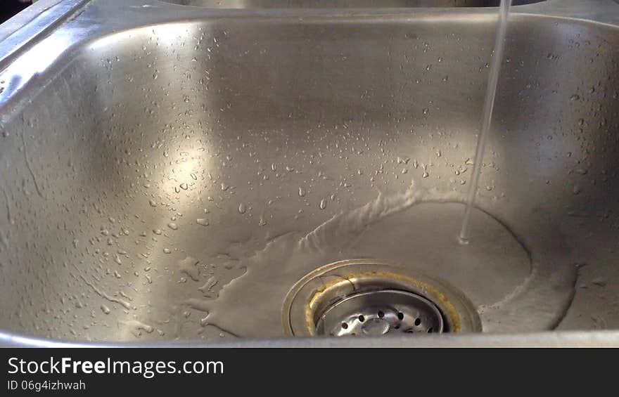 Washing hands with pink soap and running water.