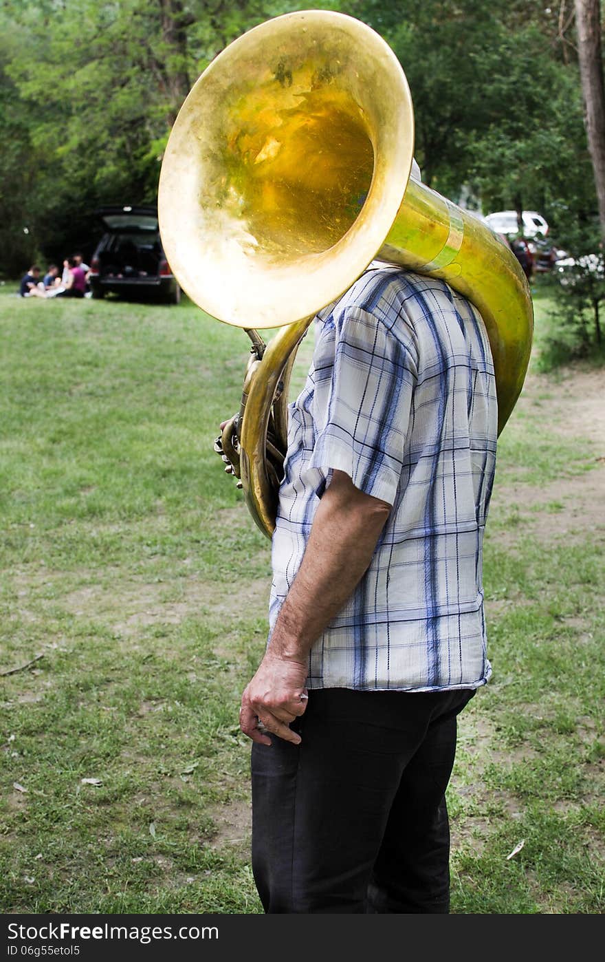 Musician playing his tube in nature. Musician playing his tube in nature