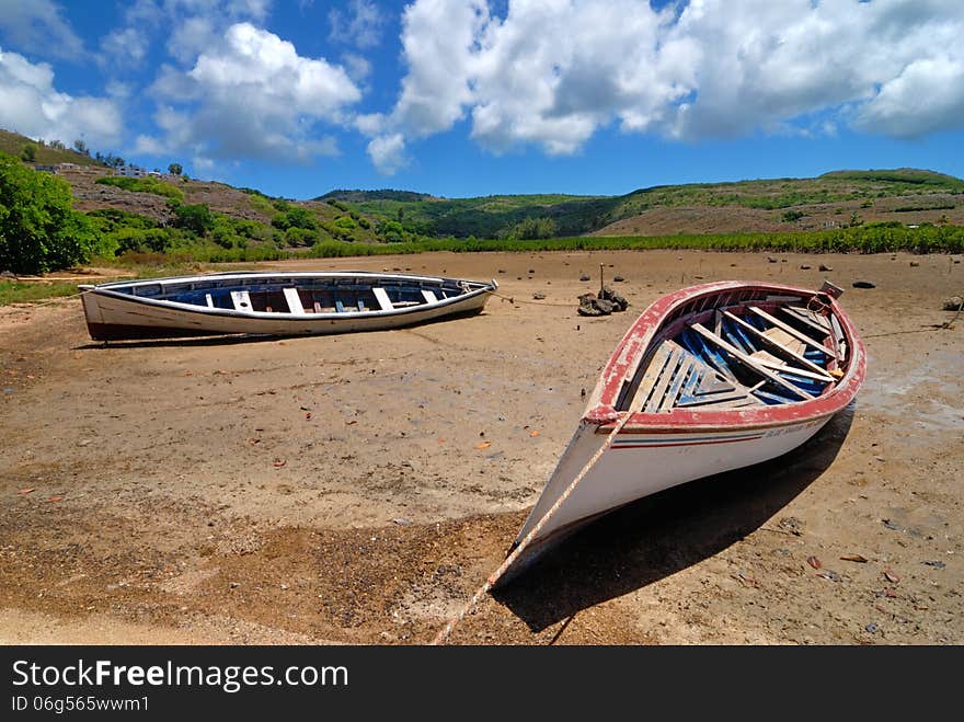 Two fishing boats on dried land at low tide