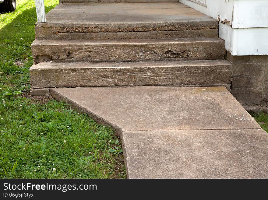 A close up of concrete stairs and sidewalk.