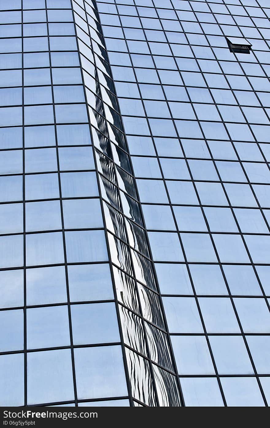 Sky reflections on a glass wall of a hotel