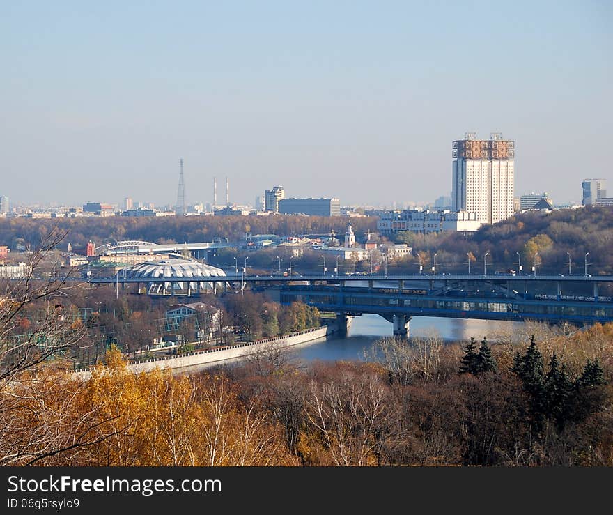 Panorama of Moscow from Sparrow hills. Autumn landscape with a view of Moskva river and a bridge across it. In the background visible to the building of the Academy of Sciences, the television tower on Shabolovka. Also you can see the dome stadium in Luzhniki.