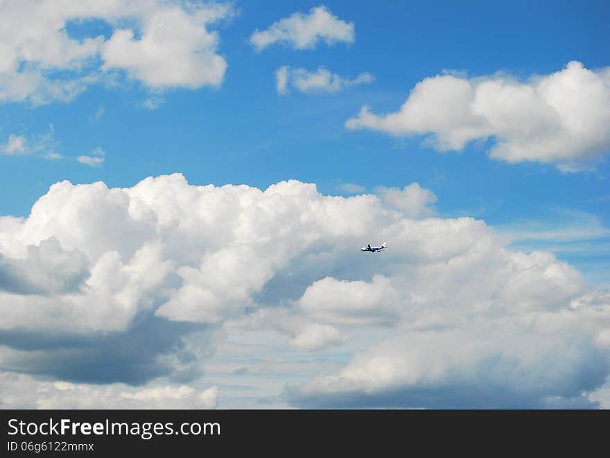 Blue sky with clouds which flies a plane