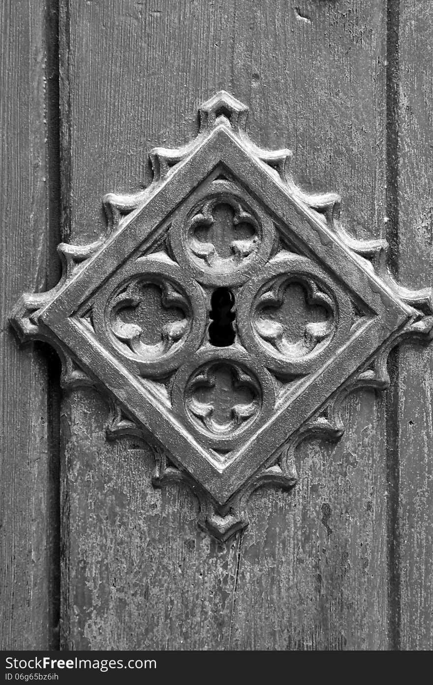 Monochromatic view of a old metal medieval door background. Vertically. Monochromatic view of a old metal medieval door background. Vertically.