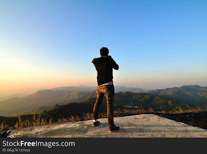 A man taking picture of Gas transmission factory at Changsuek Hill, Karnchanaburi, Thailand. A man taking picture of Gas transmission factory at Changsuek Hill, Karnchanaburi, Thailand.