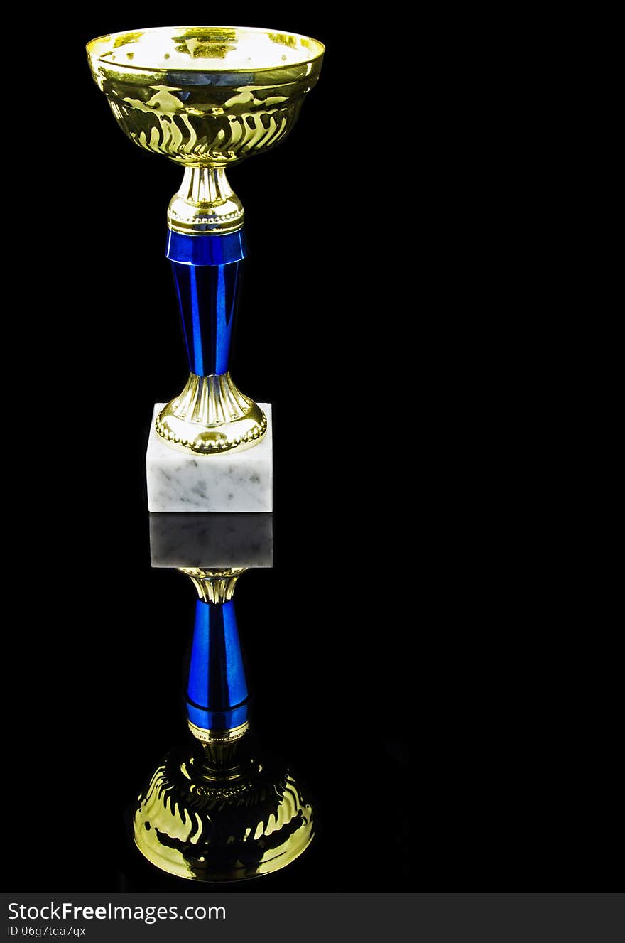 Gold trophy, black background, vertical