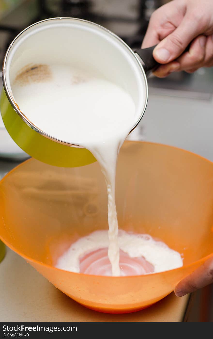 Pouring milk in a plastic bowl