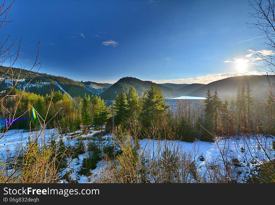 Winter Landscape With Lake, Forest And Sun.