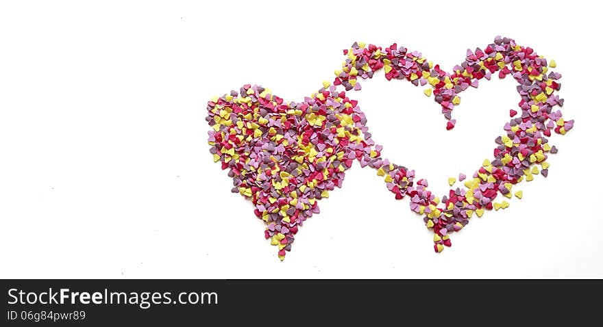 Pink heart made of candys on white background. Pink heart made of candys on white background