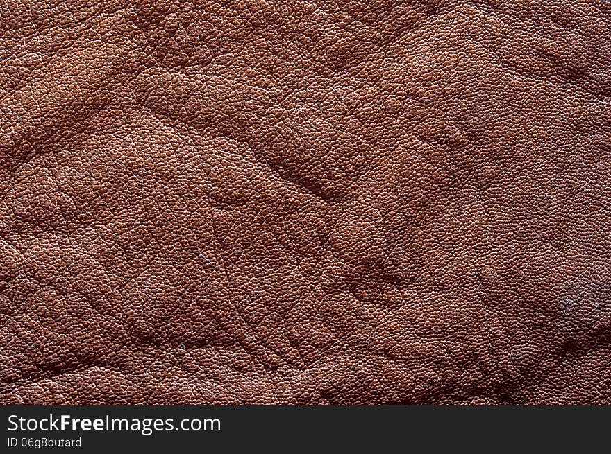 Natural brown leather texture closeup on a table.