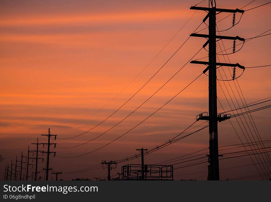 Electricity cable communication towers on sunset stretching across the river. Electricity cable communication towers on sunset stretching across the river.