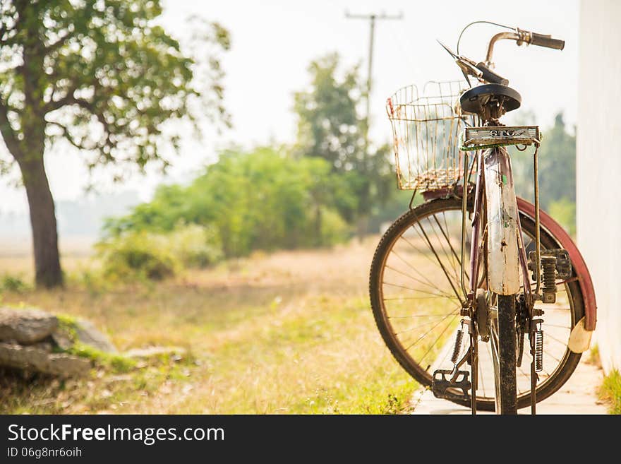 Old bicycle on the side of the house for background. Old bicycle on the side of the house for background.