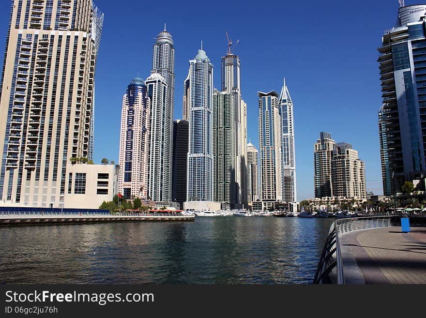 View of Dubai Marina along the sea shore with walking plaza and restaurants, Dubai. UAE.