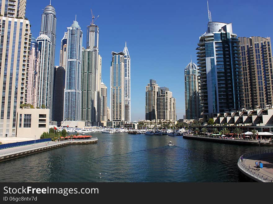 View of Dubai Marina along the sea shore with walking plaza and restaurants, Dubai. UAE.