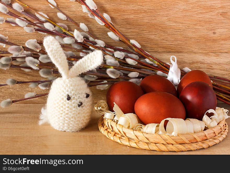 Easter eggs, rabbit and catkins on a wooden background. Easter eggs, rabbit and catkins on a wooden background