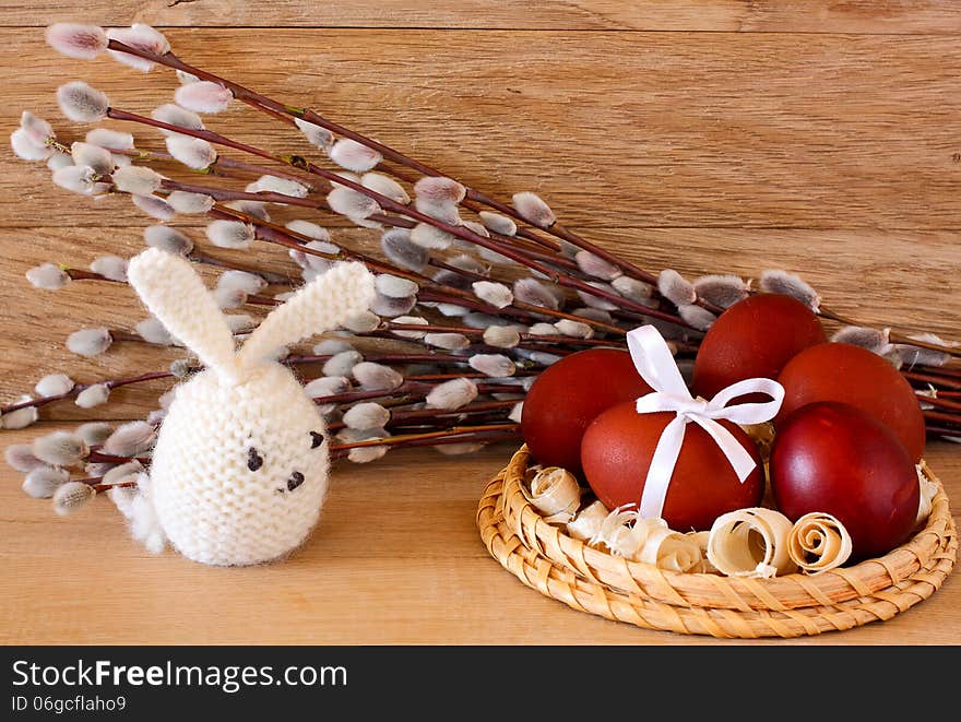 Easter eggs, rabbit and catkins on a wooden background. Easter eggs, rabbit and catkins on a wooden background