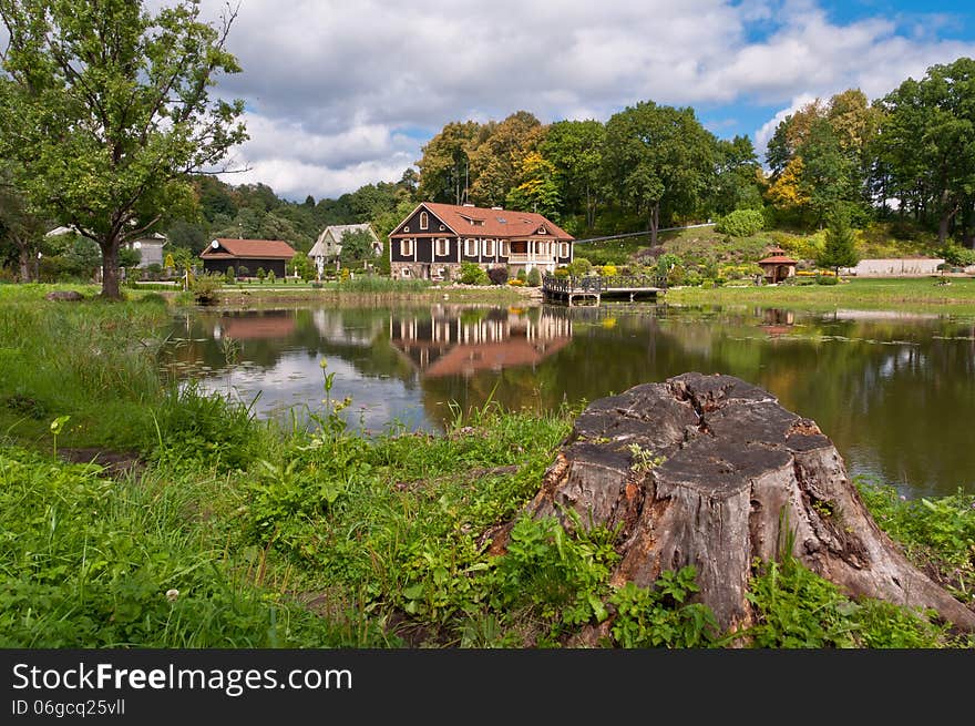 Big Family House In Front Of The Lake In The Forest