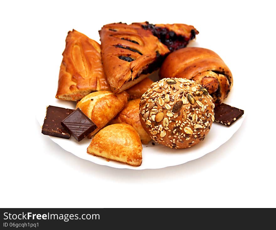 Assorted pastries and pies with filling on isolated background, baking on a white plate. Assorted pastries and pies with filling on isolated background, baking on a white plate