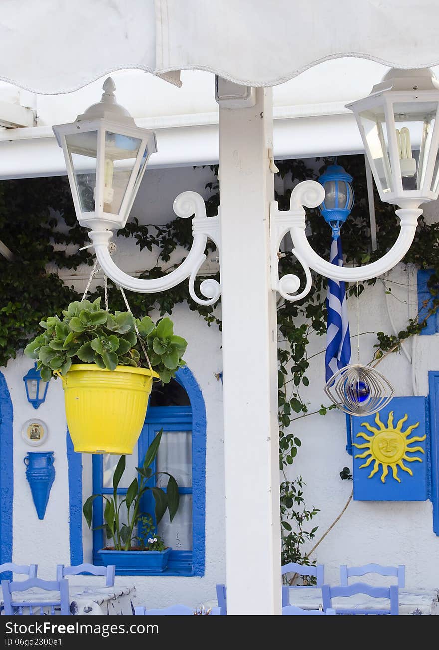 Lantern and flower pot at typical Greek street restaurant, Kos, Greece.