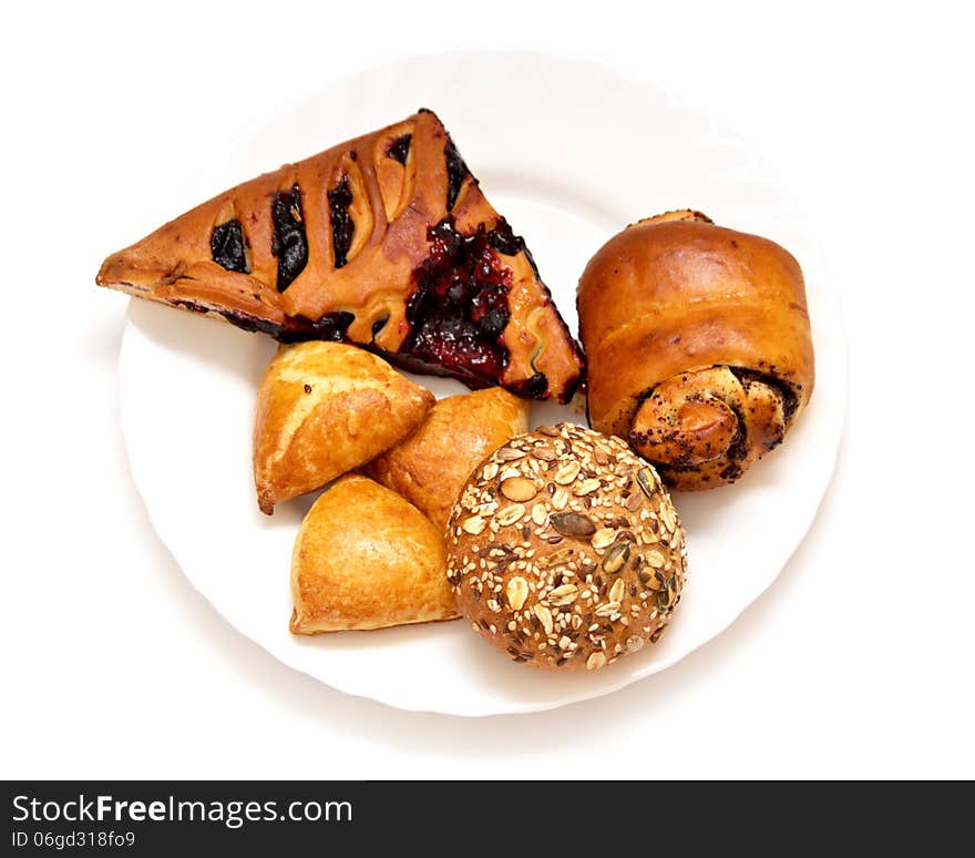 Assorted pastries and pies with filling on isolated background, baking on a white plate baking on a white plate. Assorted pastries and pies with filling on isolated background, baking on a white plate baking on a white plate