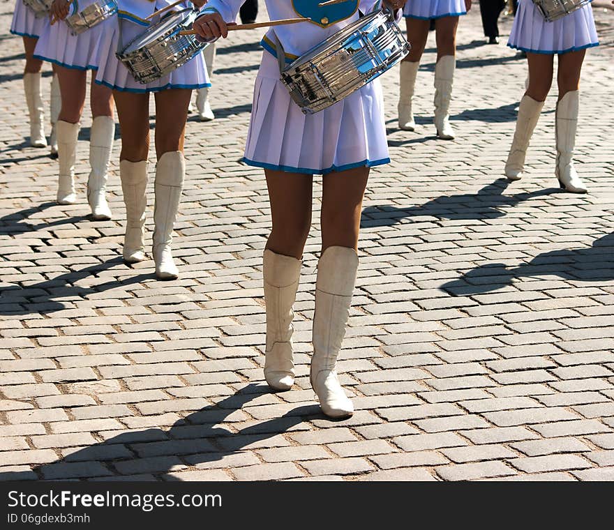 Drummer girls march on city day on sunny summer day