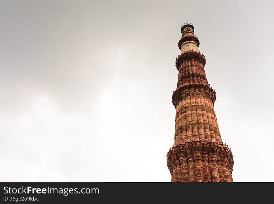 Qutub Minar tower on dull sky,UNESCO World Heritage