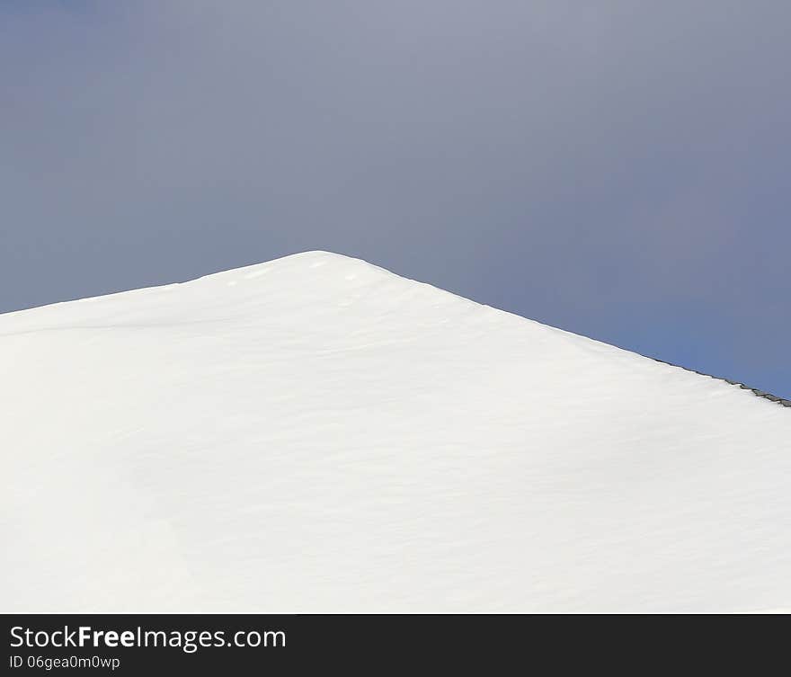 Fresh fallen snow sitting on slated roof. Fresh fallen snow sitting on slated roof