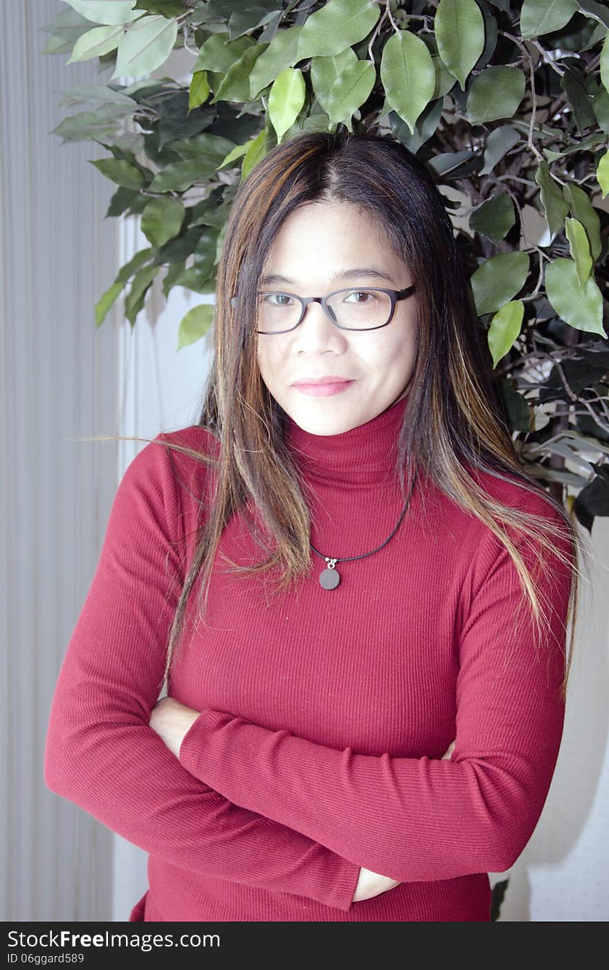 A young asian woman waiting patiently by the window. A young asian woman waiting patiently by the window.