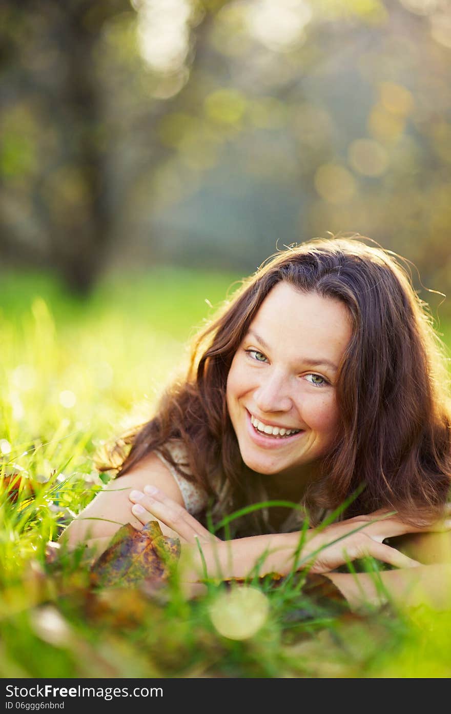 Young girl, laughing, lying on the grass. Young girl, laughing, lying on the grass