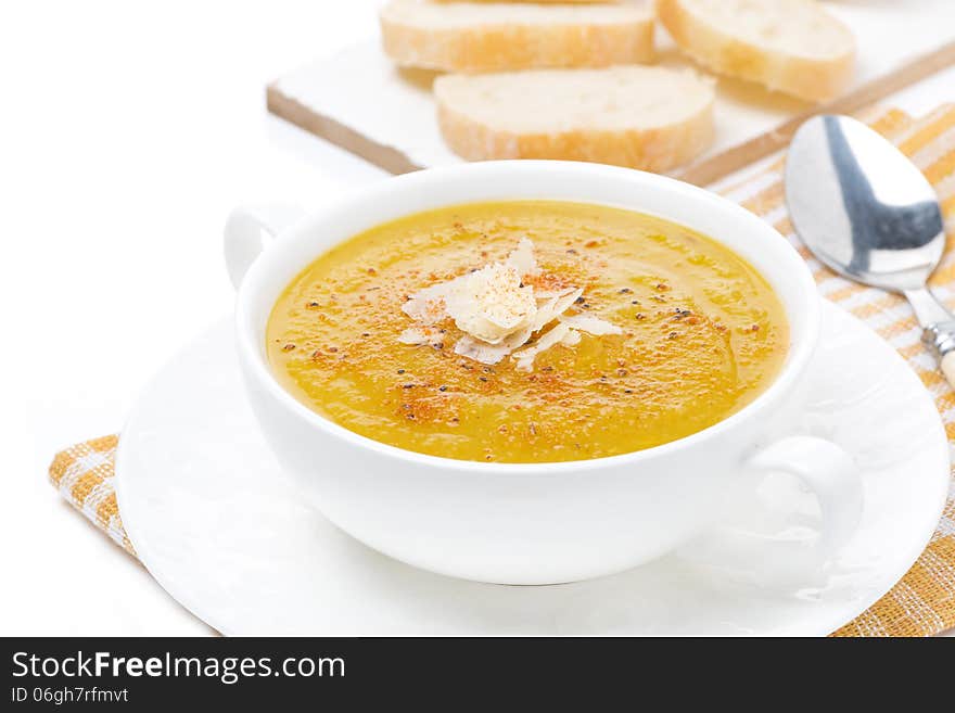 Cream soup of yellow lentils with vegetables in a bowl, isolated