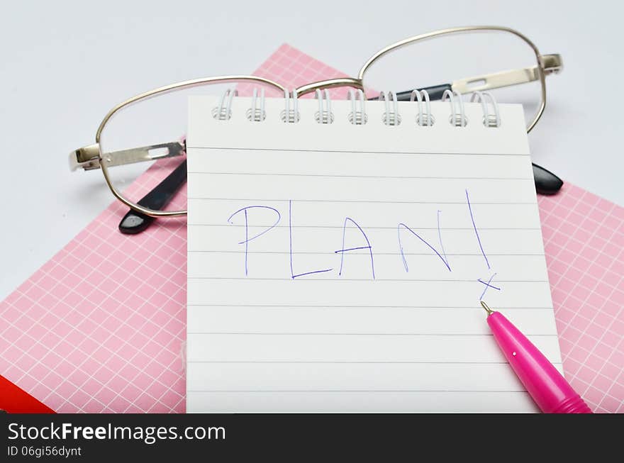 Pink pen notebook and glasses wording plan