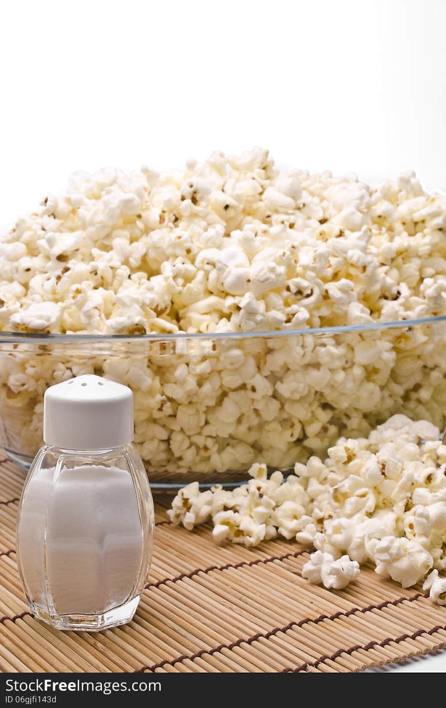 Wooden toothpicks, salt and popcorn on white background