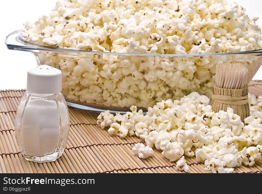 Wooden toothpicks, salt and popcorn on white background