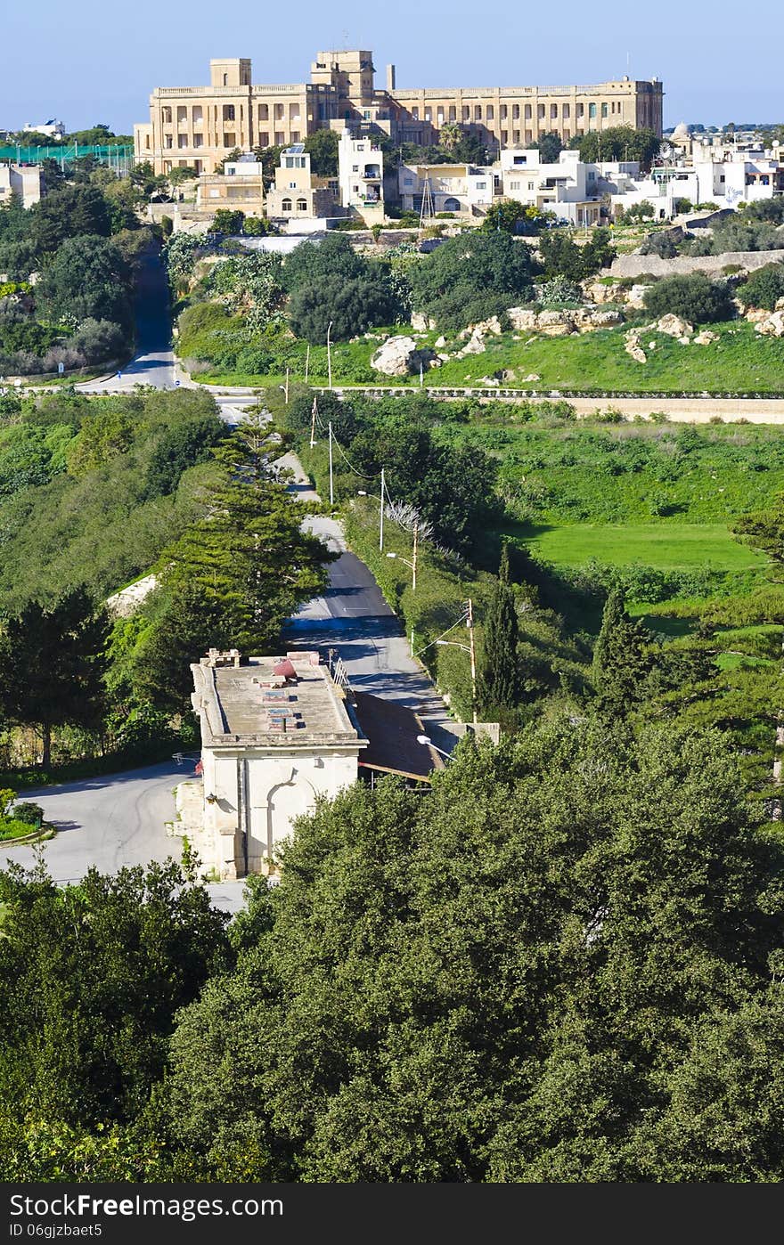 An old railway station found on the island of Malta. In the background an old hospital is also visible. An old railway station found on the island of Malta. In the background an old hospital is also visible.