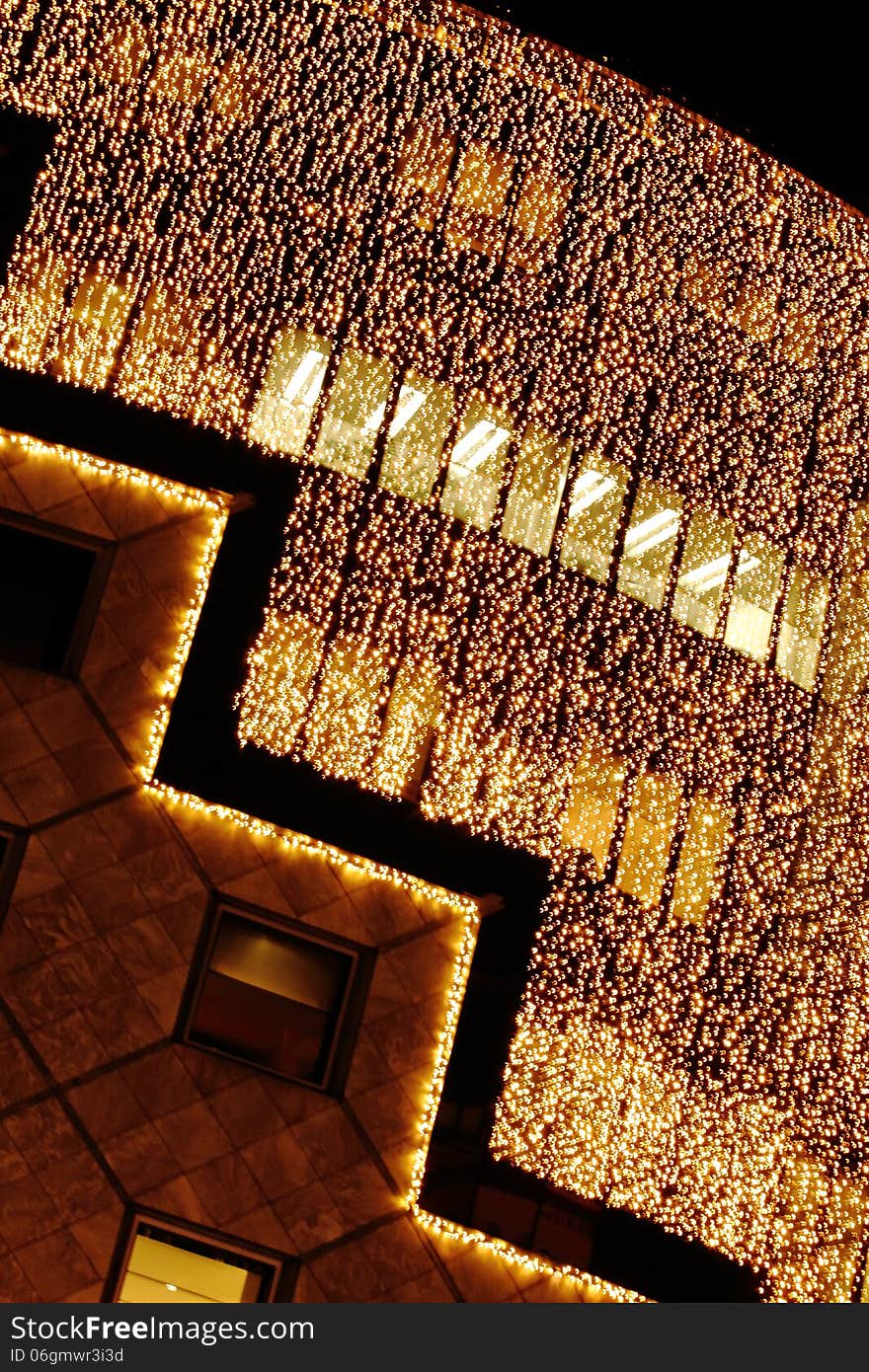 The front of an elegant store in vienna, austria covered with a curtain consisting of many small lights, thus generating a glitterig christmas illumination. The front of an elegant store in vienna, austria covered with a curtain consisting of many small lights, thus generating a glitterig christmas illumination