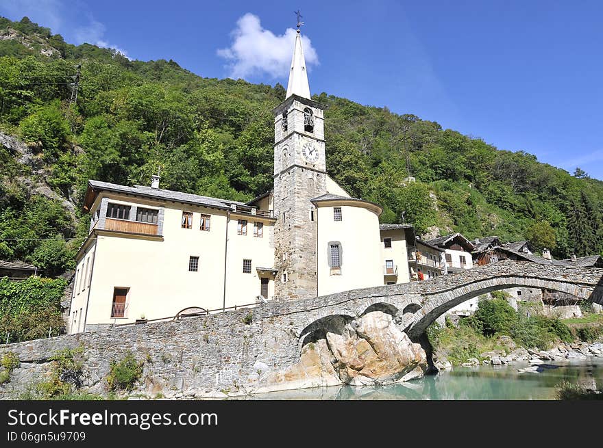 Roman bridge with church in Fontainemore, Aosta Valley, Italy